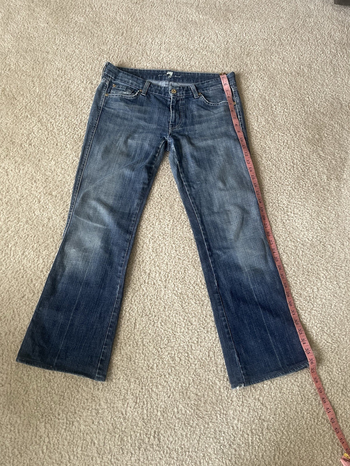 7 For All Mankind low-rise bootcut jeans featuring a medium wash Size 31