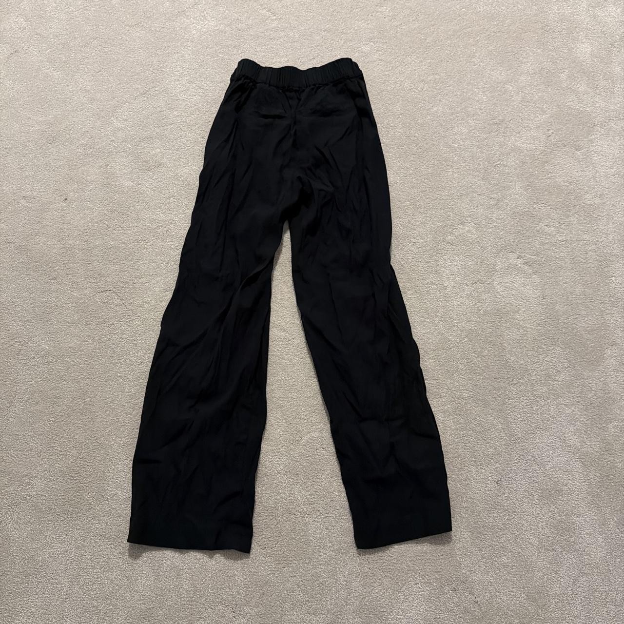 Vince black pull-on trousers with an elastic waist and relaxed wide leg cut