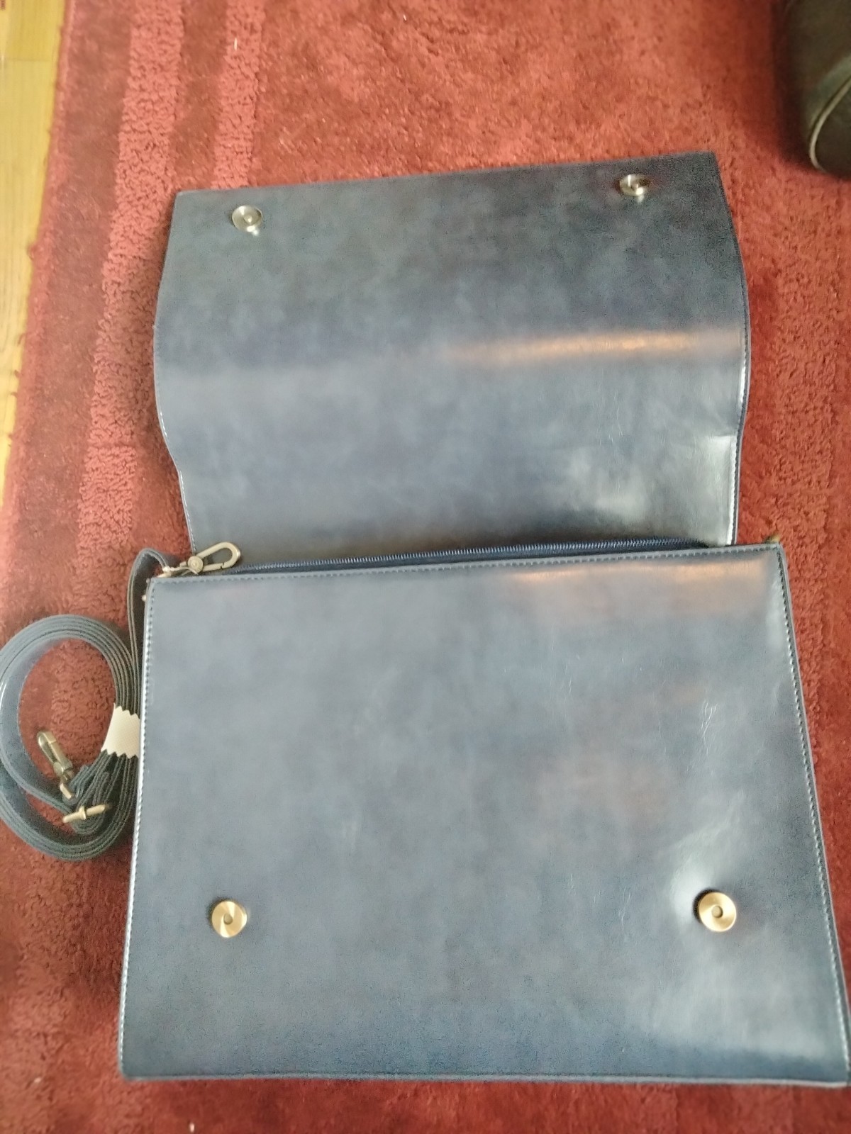 ECOSUSI briefcase features vegan leather construction and a protective handle…