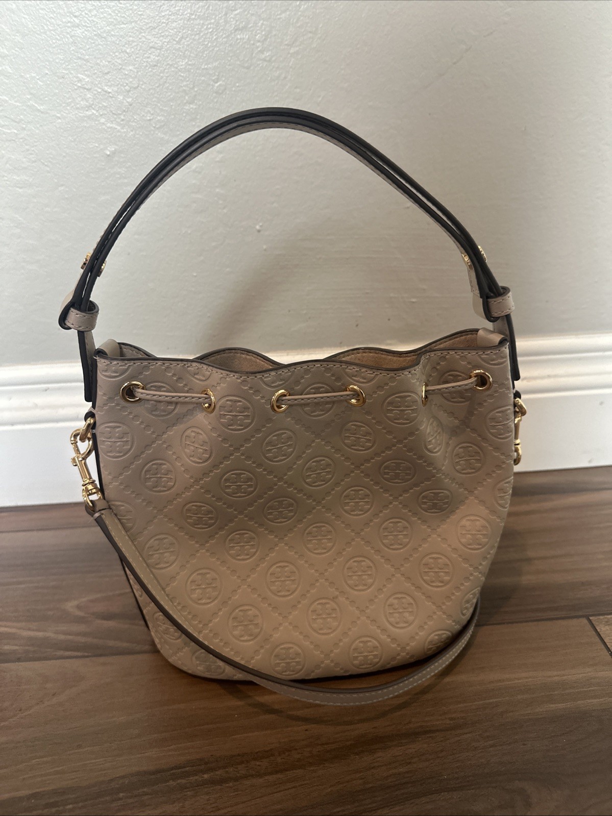 Tory Burch T Monogram debossed leather bucket bag in a “Fresh Clay”