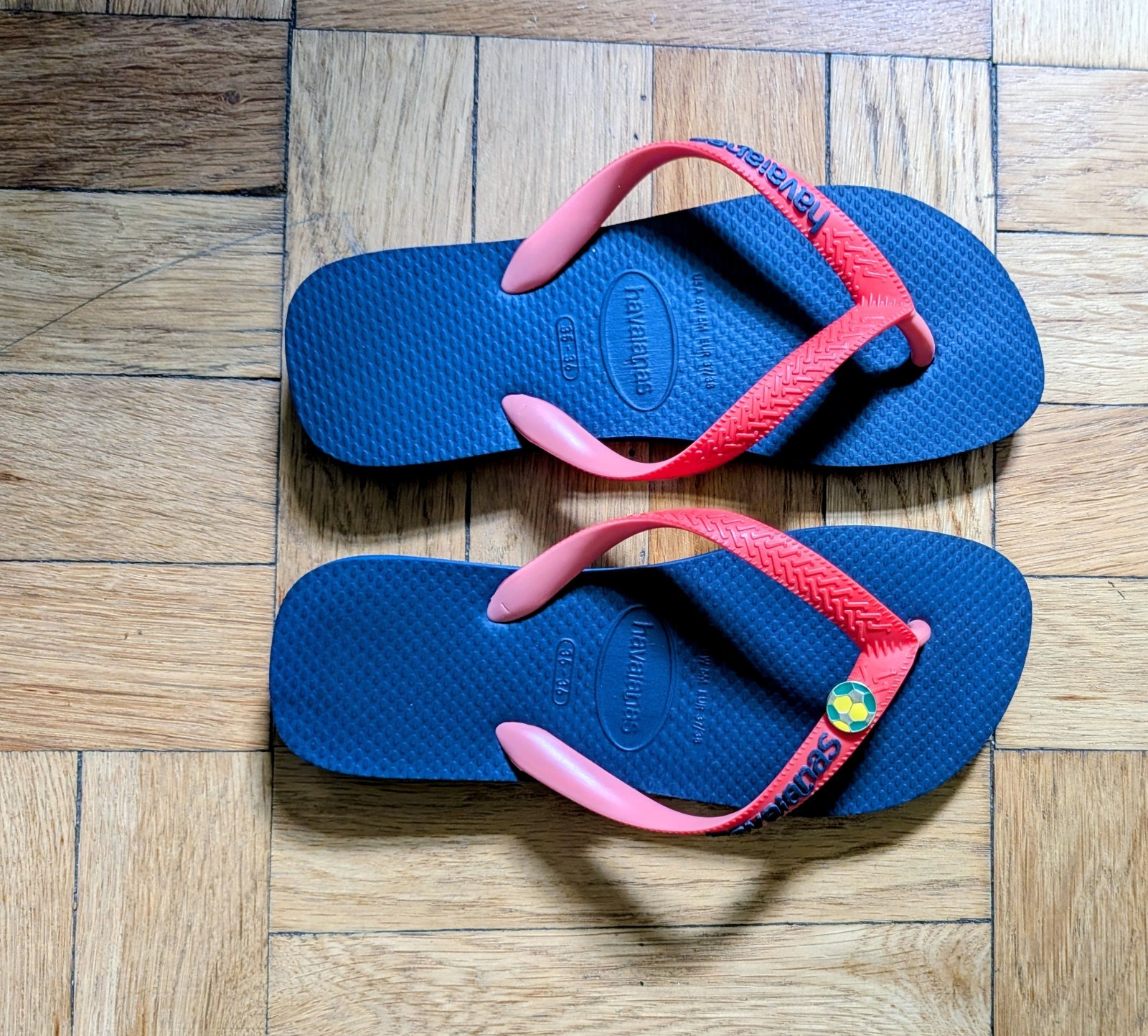 Havaianas Blue and red flip flap with soccer pin. size 6.