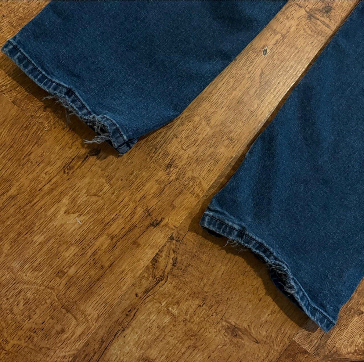 faded Levi’s 514 blue jeans size 38×30 with distressed areas, straight-leg
