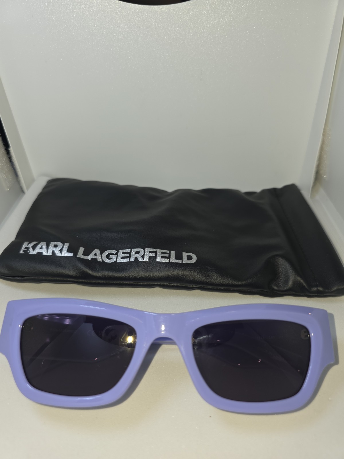 Karl Lagerfeld rectangular sunglasses with a lavender frame and dark lenses