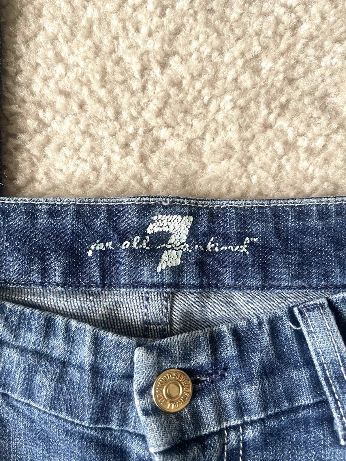 7 For All Mankind low-rise bootcut jeans featuring a medium wash Size 31