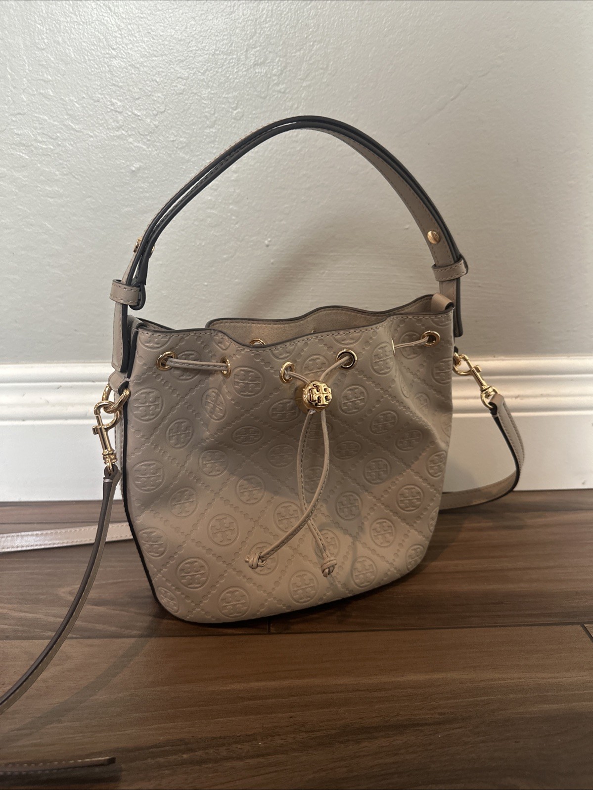 Tory Burch T Monogram debossed leather bucket bag in a “Fresh Clay”