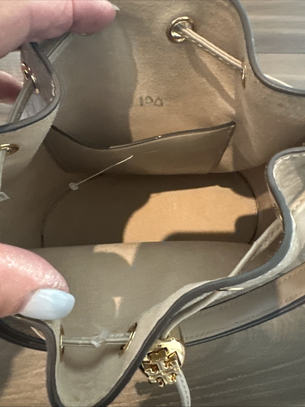 Tory Burch T Monogram debossed leather bucket bag in a “Fresh Clay”