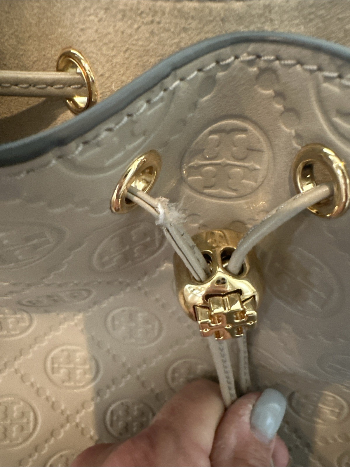 Tory Burch T Monogram debossed leather bucket bag in a “Fresh Clay”