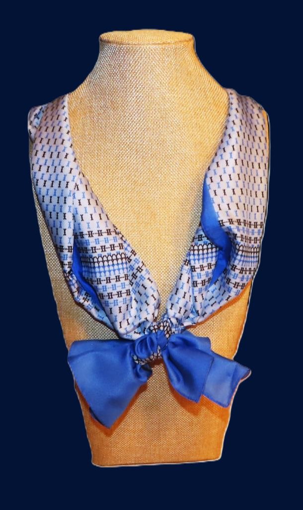 Oblong abstract scarf; blue tones, white; polyester; 54 x 10.5 inches