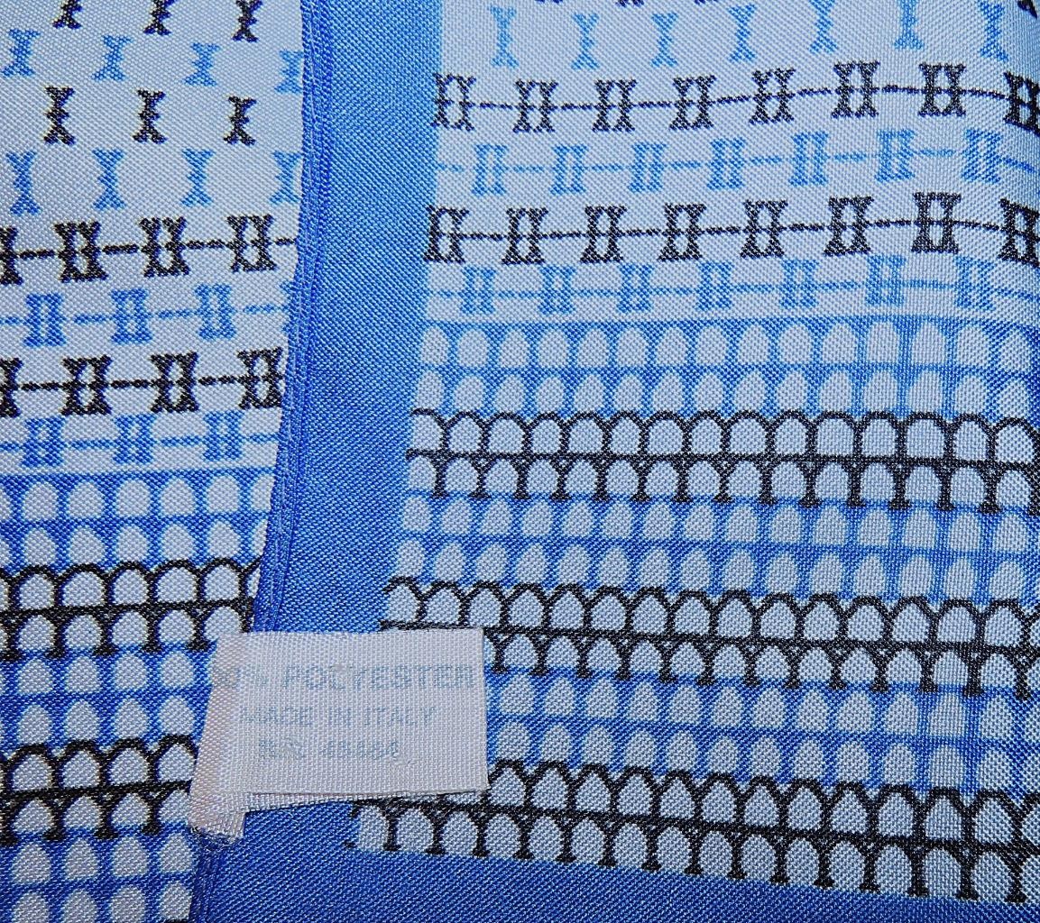 Oblong abstract scarf; blue tones, white; polyester; 54 x 10.5 inches
