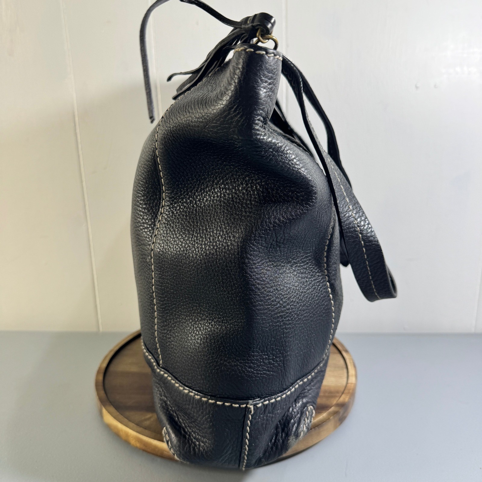 The Sak Black Leather Tote Bag With White Stitching And Tassel Accent Timeless