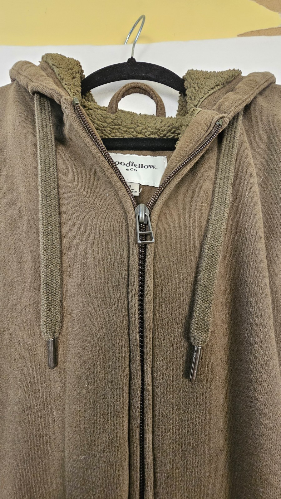 olive green full-zip hoodie features a cozy fleece lining, an adjustable drawstr
