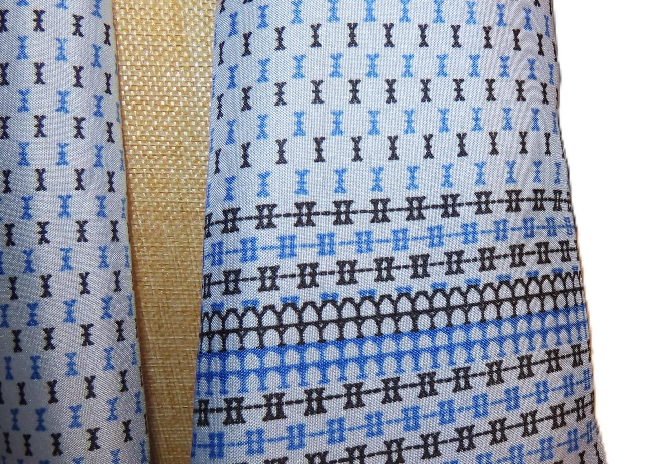 Oblong abstract scarf; blue tones, white; polyester; 54 x 10.5 inches