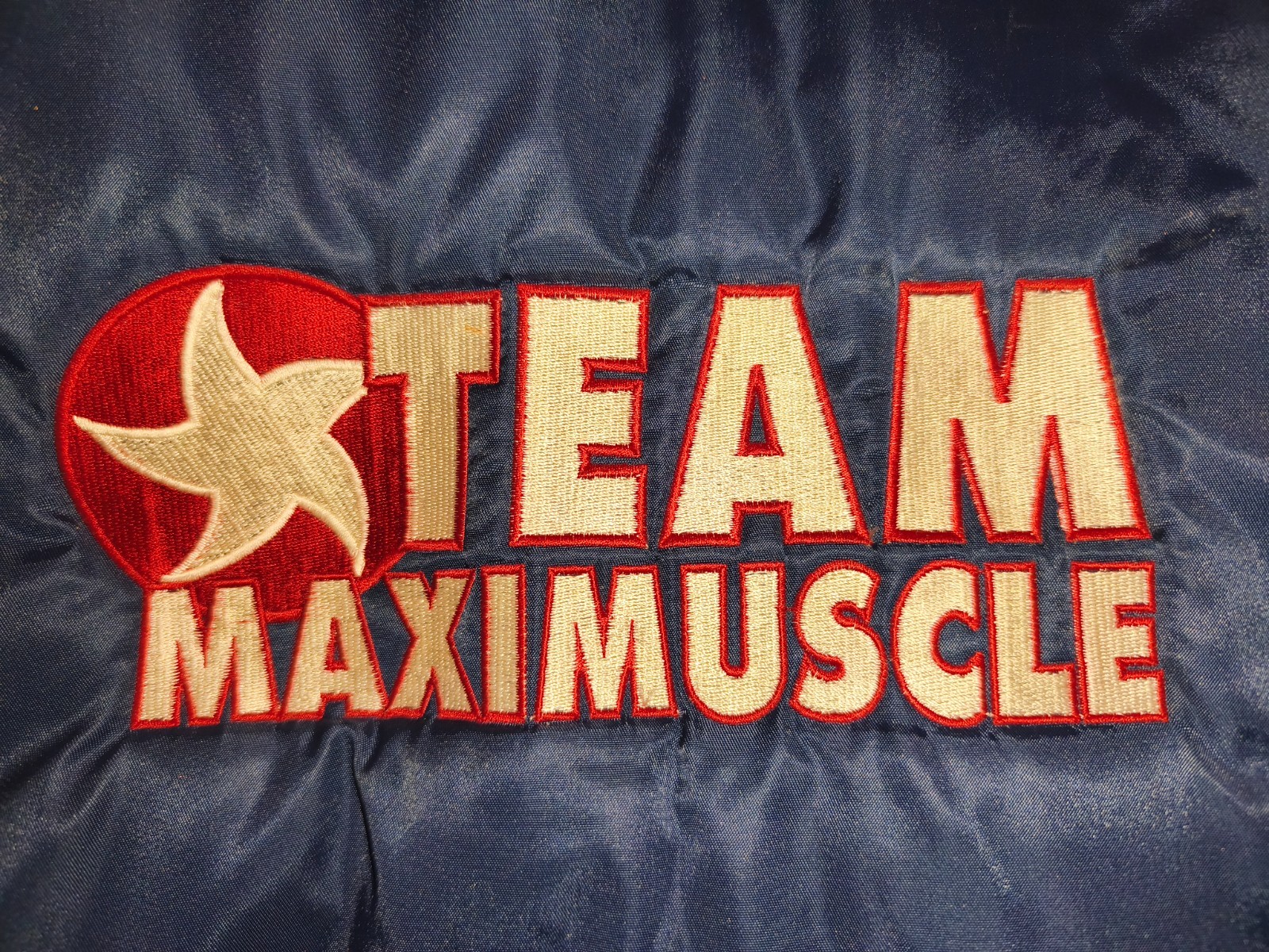 Classic 90s/Y2K bomber jacket featuring bold “Team Maximuscle” chest & back embr