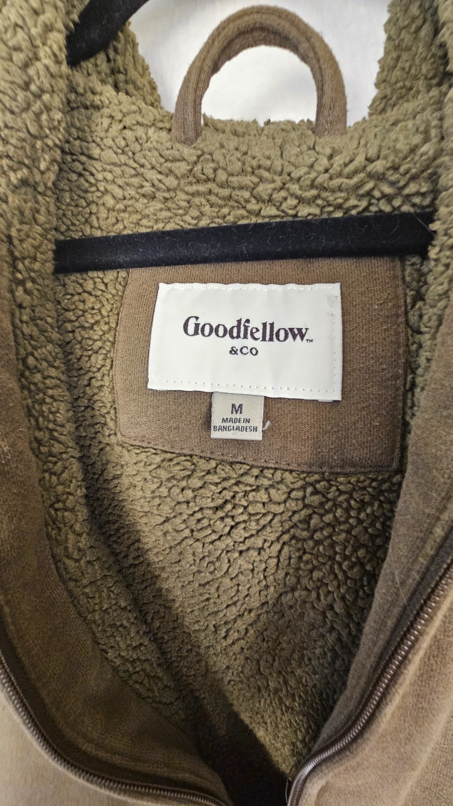 olive green full-zip hoodie features a cozy fleece lining, an adjustable drawstr
