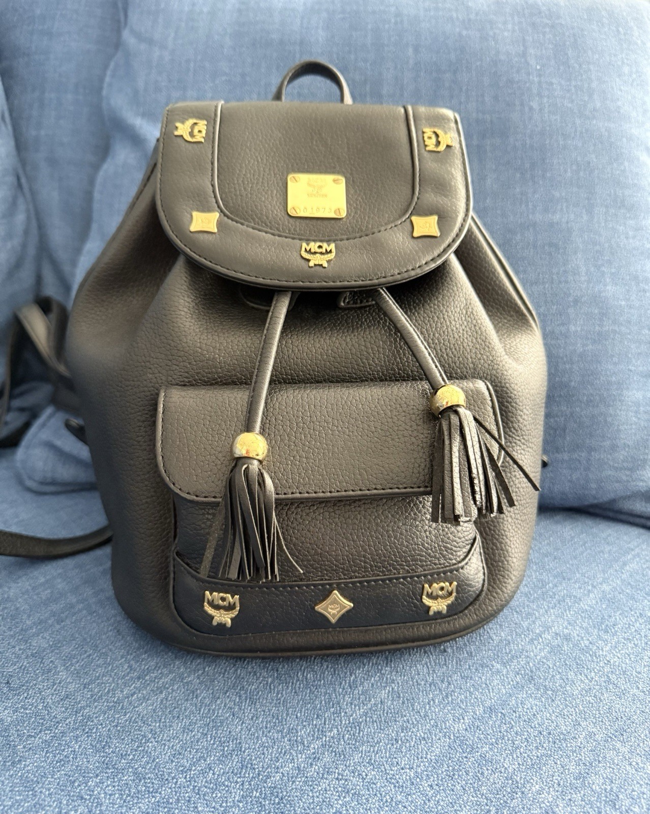 MCM Black Pebbled Drawstring Backpack Gold Hardware Logo Tassel Bag Charm