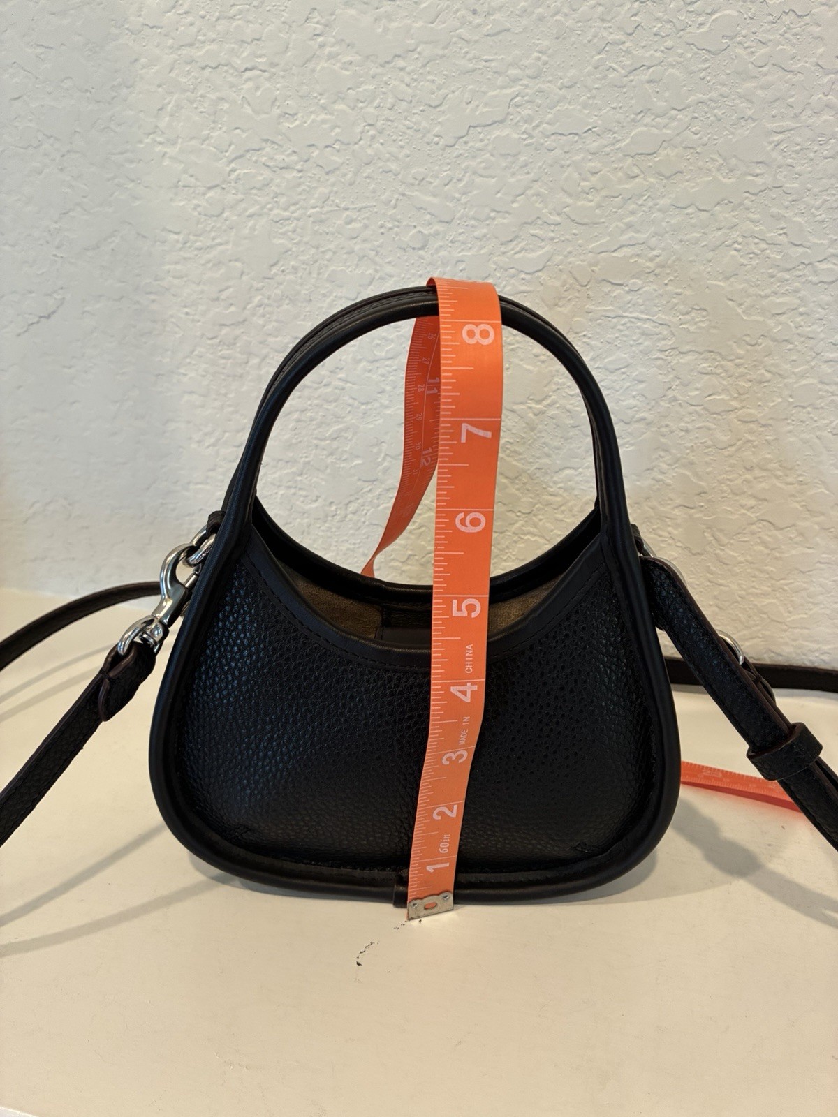 Coachtopia Mini Ergo Bag crafted from black pebbled Coachtopia leather
