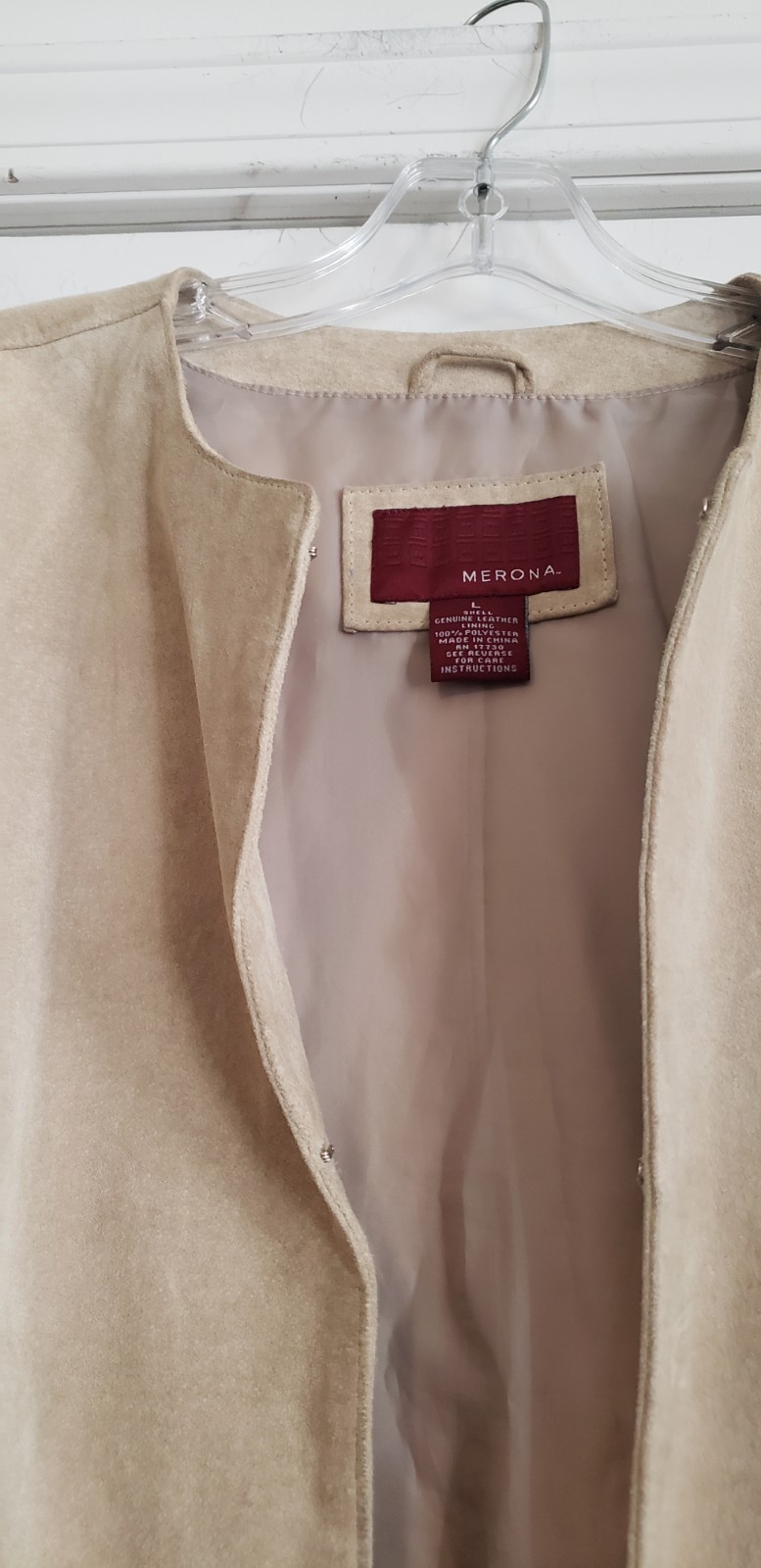 Merona beige collarless suede jacket. It features a minimalist, open-front…
