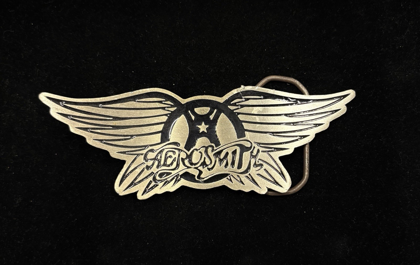 Vintage Aerosmith belt buckle features a metallic wings logo design RARE