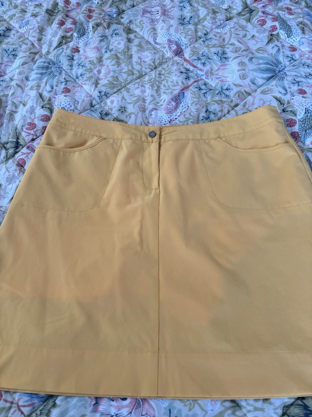 Womens Skorts (4). White, turquoise, tan and yellow. Size 12.