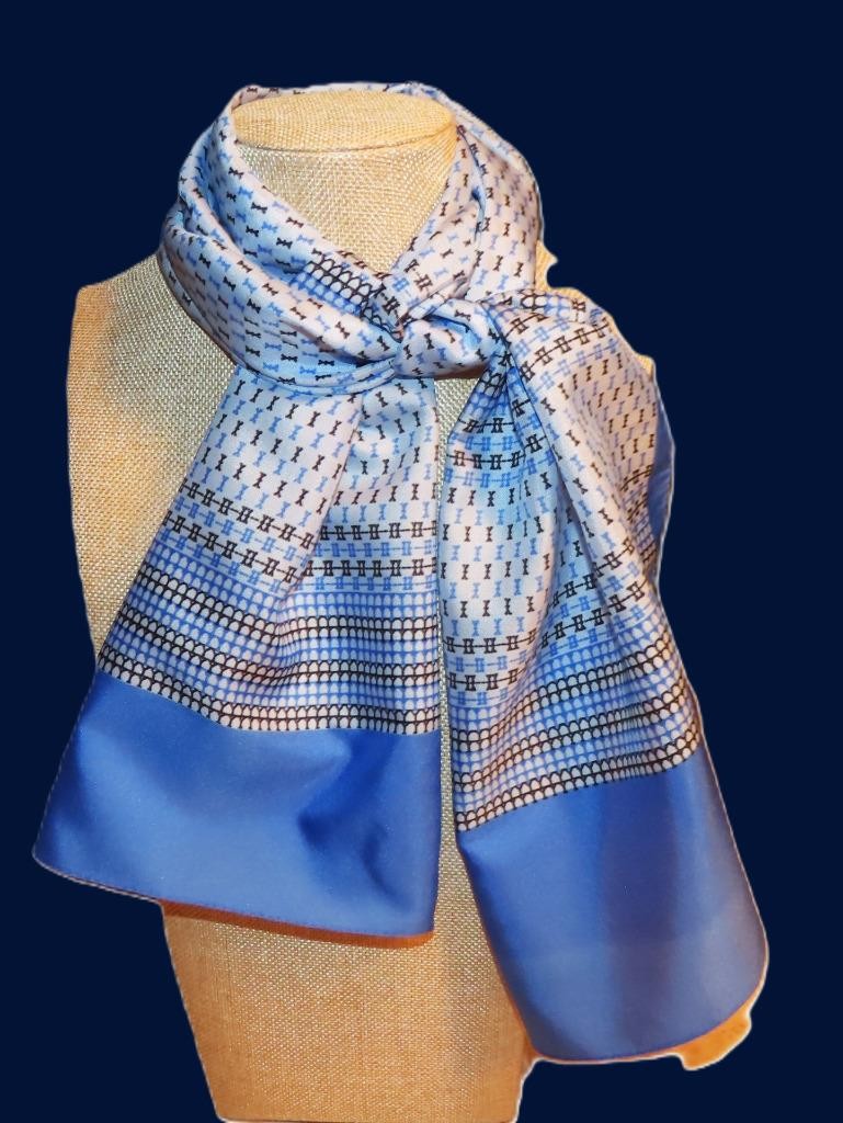 Oblong abstract scarf; blue tones, white; polyester; 54 x 10.5 inches