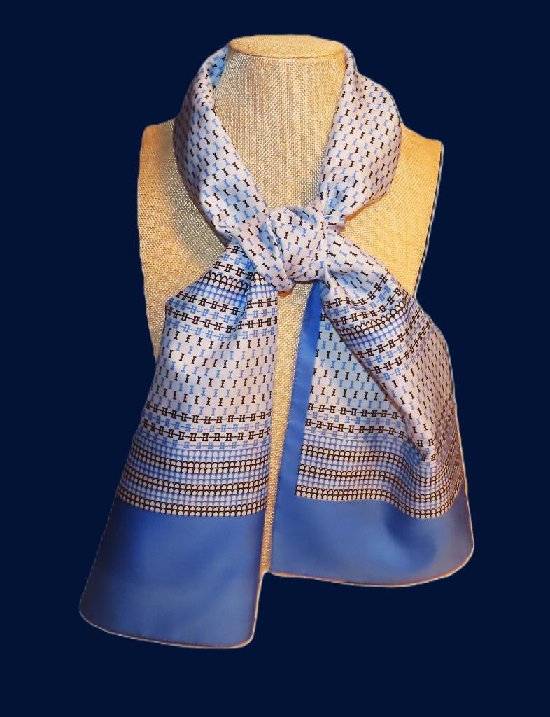 Oblong abstract scarf; blue tones, white; polyester; 54 x 10.5 inches