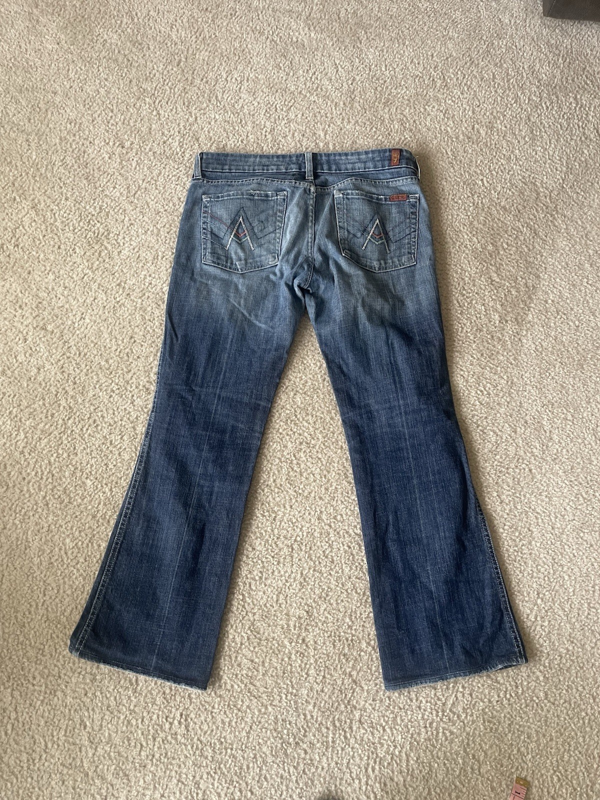 7 For All Mankind low-rise bootcut jeans featuring a medium wash Size 31