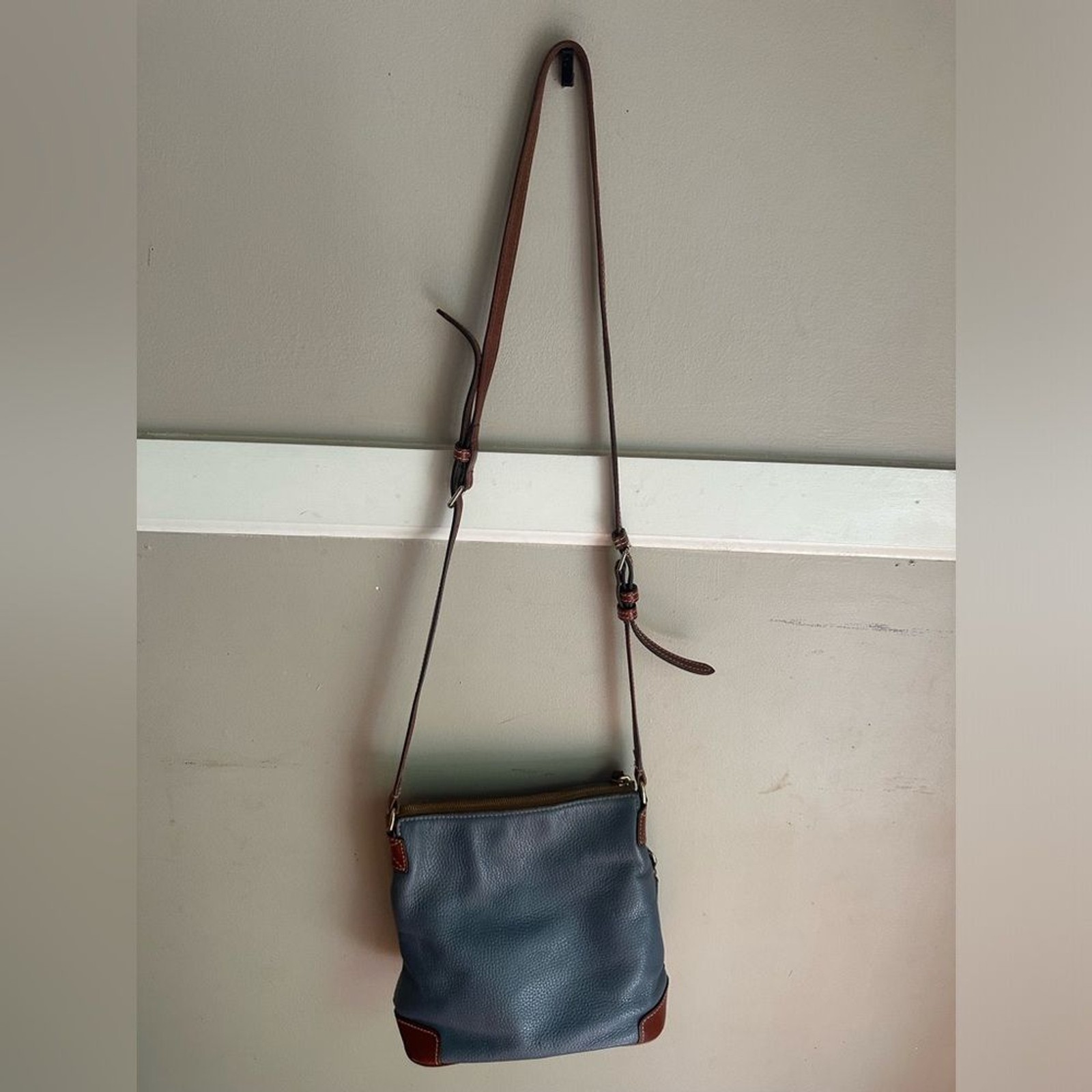 Dooney & Bourke crossbody bag leather in a shade of blue and brown leather trim