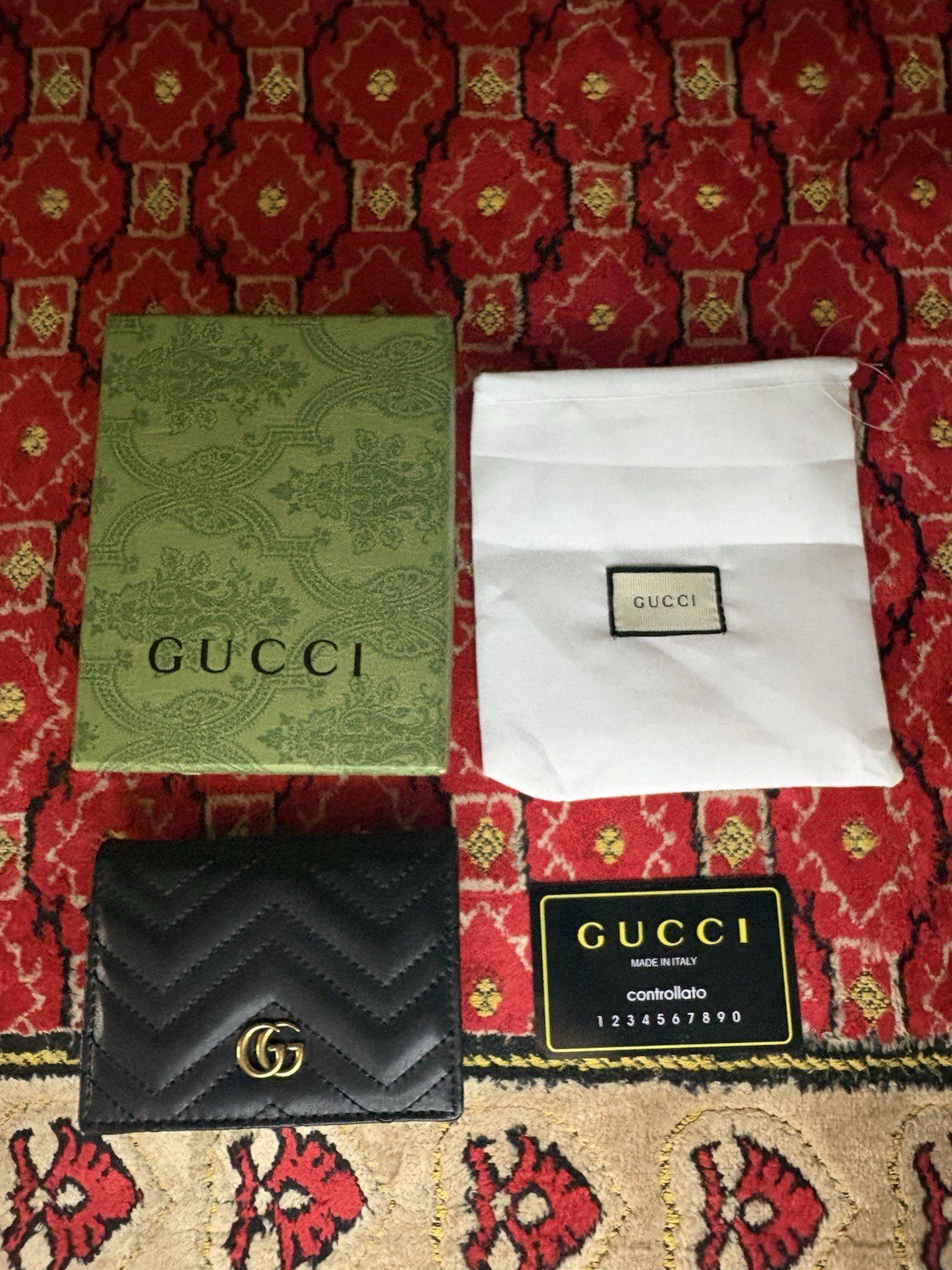 Gucci GG Marmont card case wallet in black quilted chevron leather.
