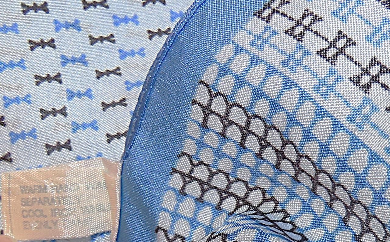 Oblong abstract scarf; blue tones, white; polyester; 54 x 10.5 inches