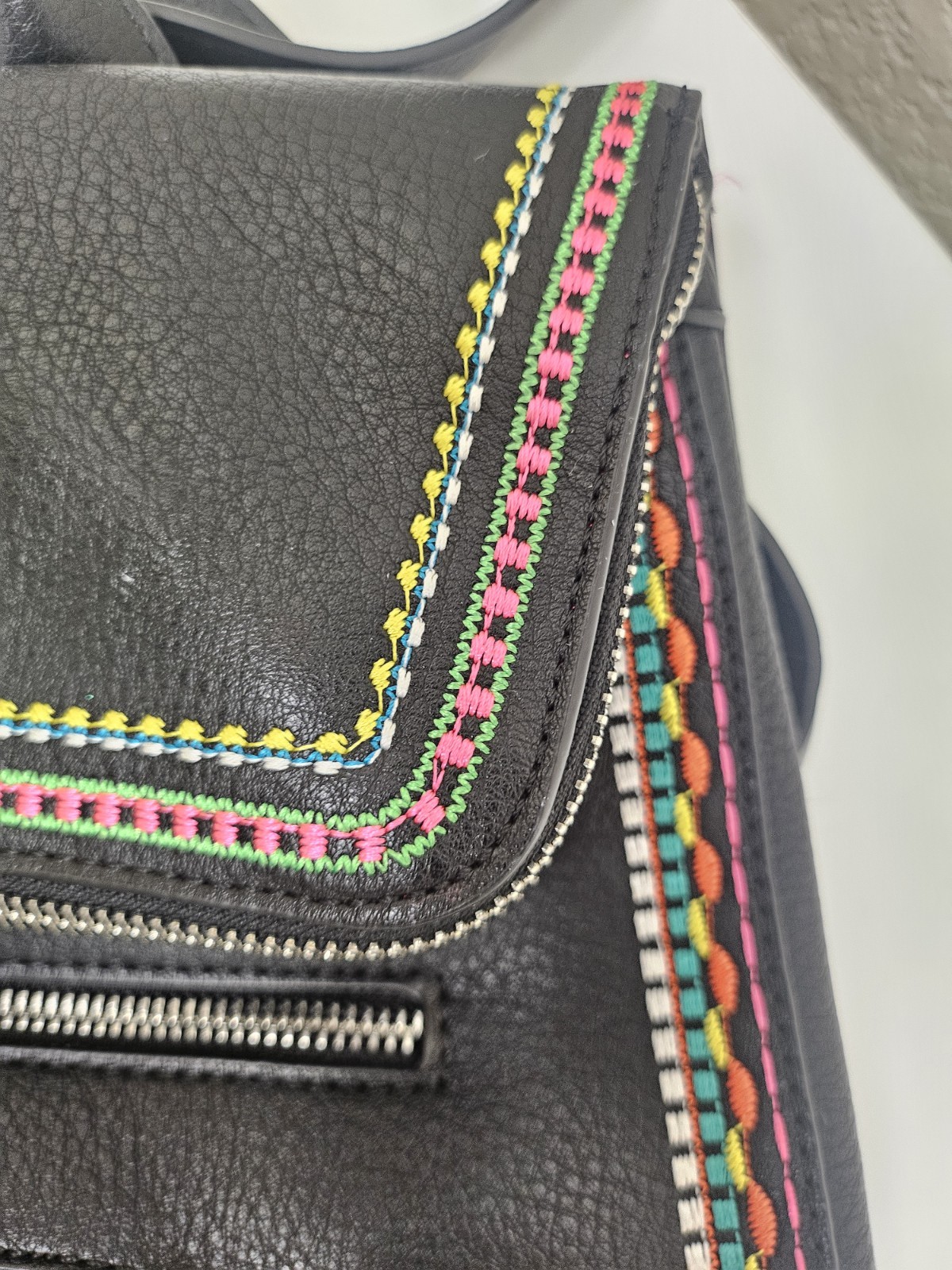 Midsize backpack,multicoloured embroidery,magnetic flap closure, zip, pockets.