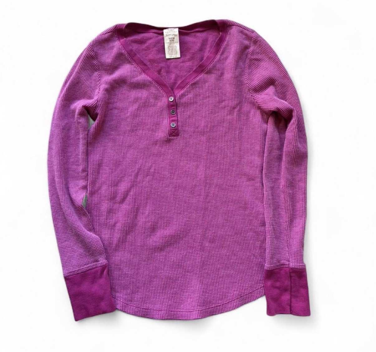 Y2K Waffle knit henley with a threebutton placket. Long sleeves and fitted cuffs