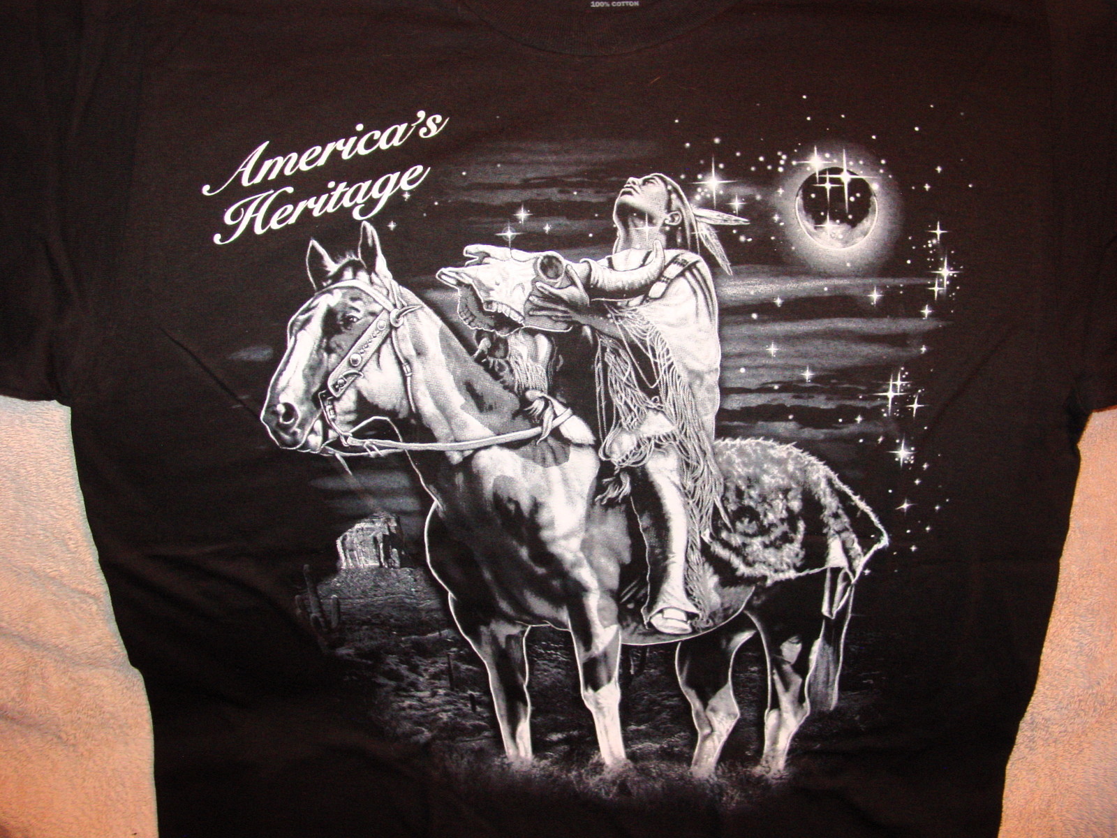 INDIAN ON HORSE HOLDING BULL SKULL AMERICA’S HERITAGE T-SHIRT
