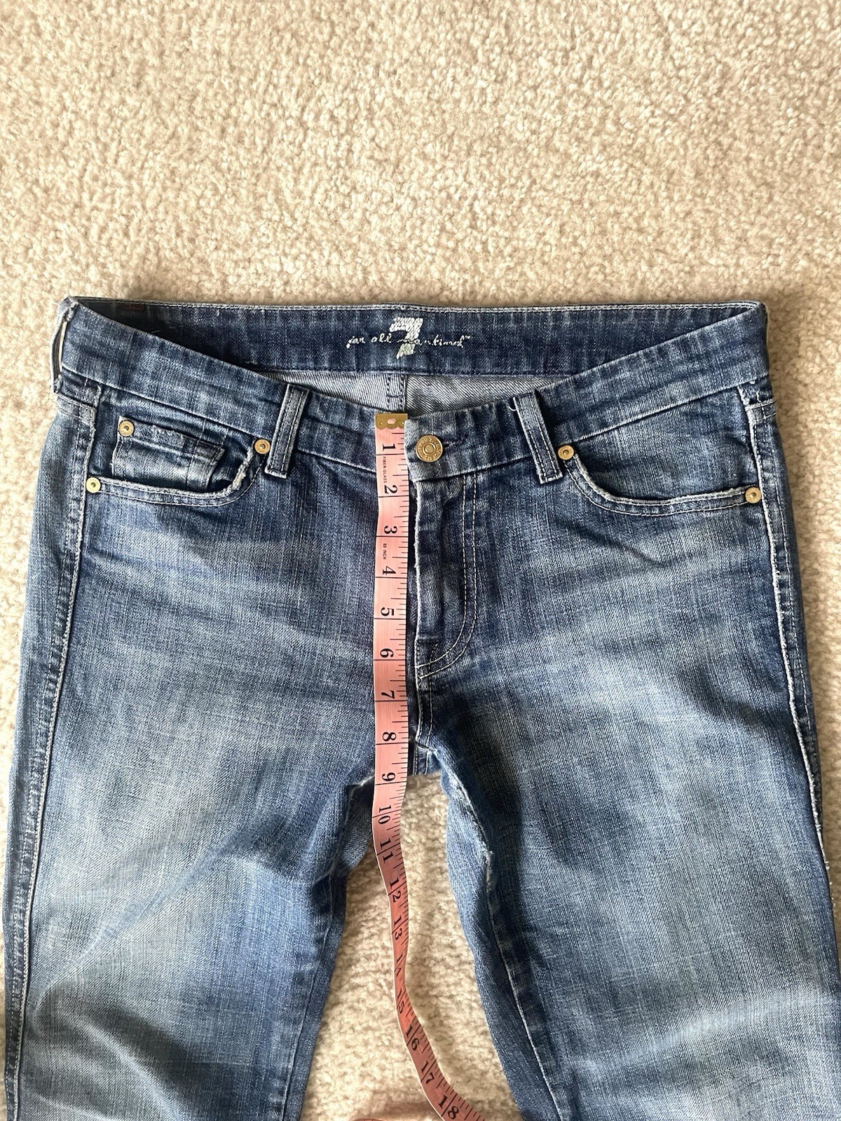 7 For All Mankind low-rise bootcut jeans featuring a medium wash Size 31