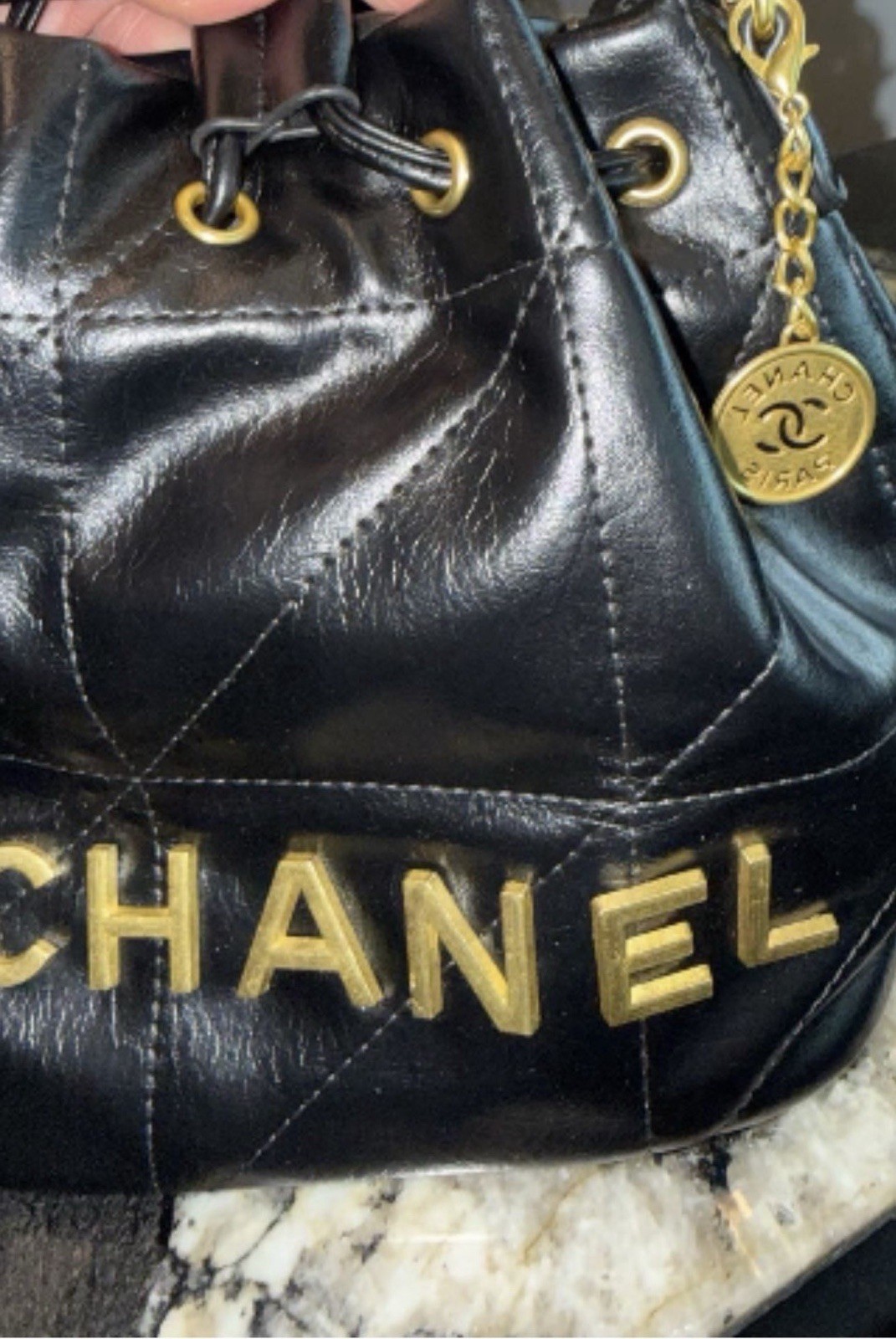 CHANEL Mini Black Quilted Drawstring Bucket Bag with Gold Chain Strap Charm
