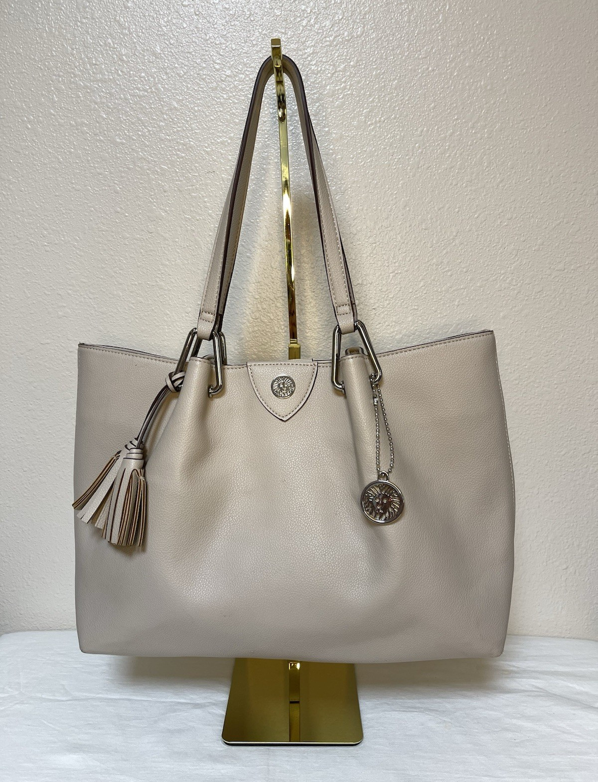 Anne Klein Taupe Vegan Pebbled Texture Tote with Lion and Tassel Charms