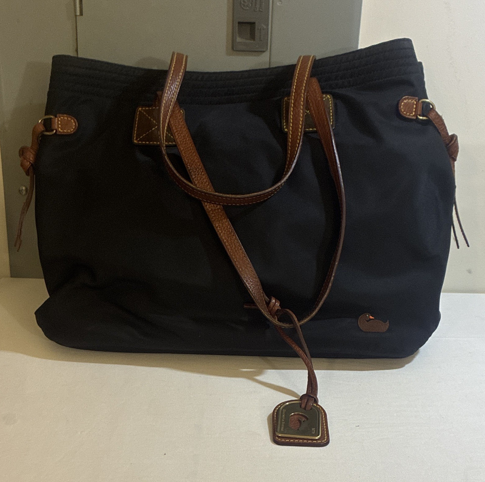 Dooney & Bourke Black Tote Bag, Zip & Magnetic Closure, Gold Hardware, Charm