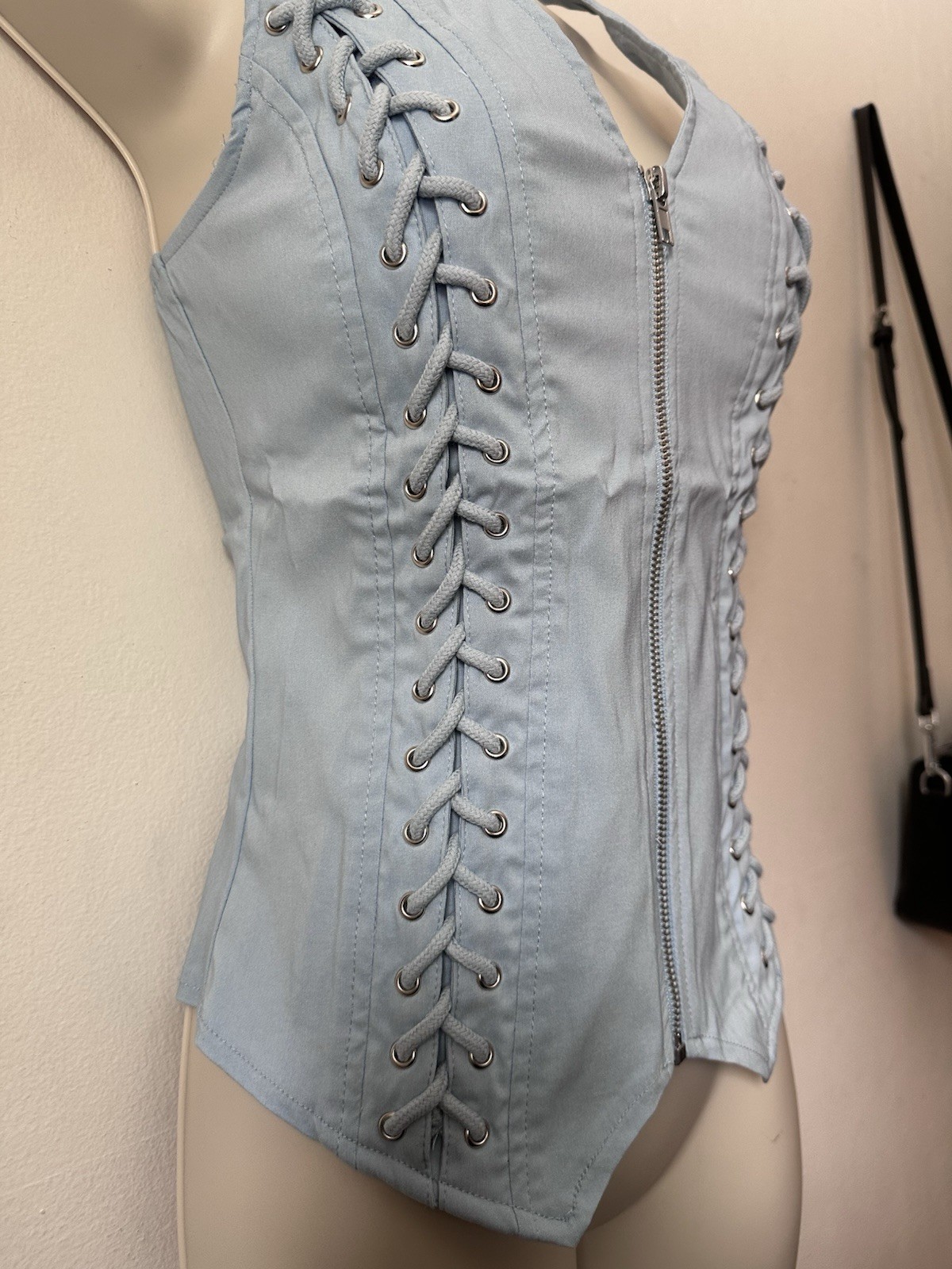 Light blue corset top with zipper and lace up details