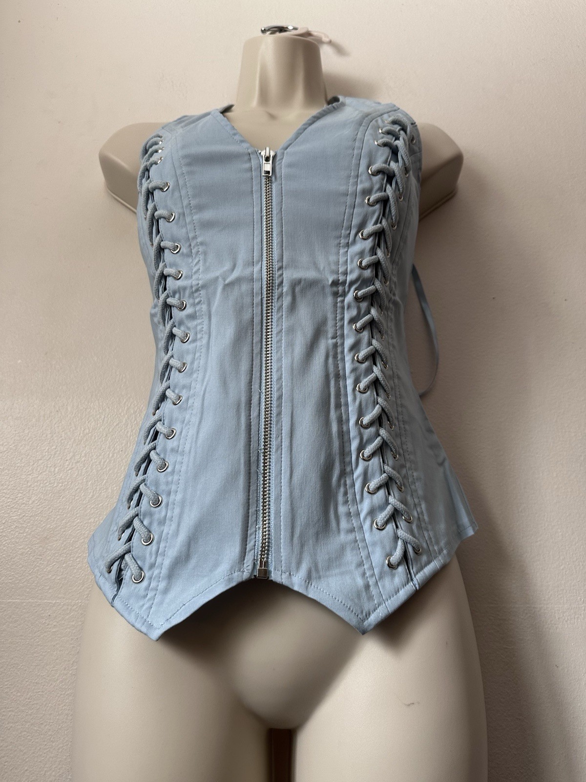 Light blue corset top with zipper and lace up details