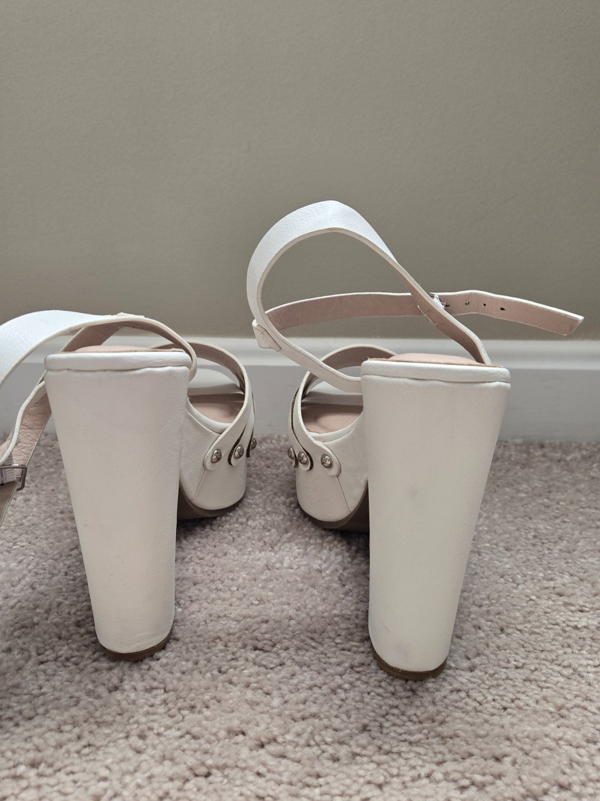 Brand new. Never worn. White faux soft leather high heels with wide heel