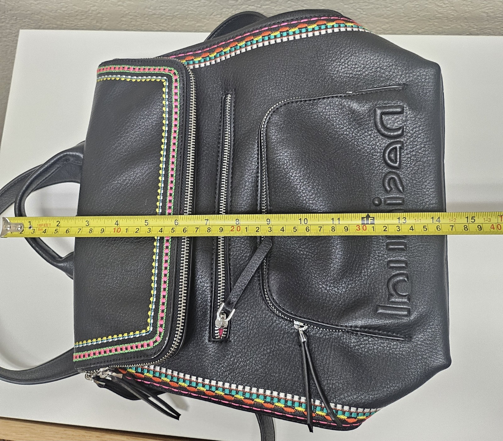 Midsize backpack,multicoloured embroidery,magnetic flap closure, zip, pockets.