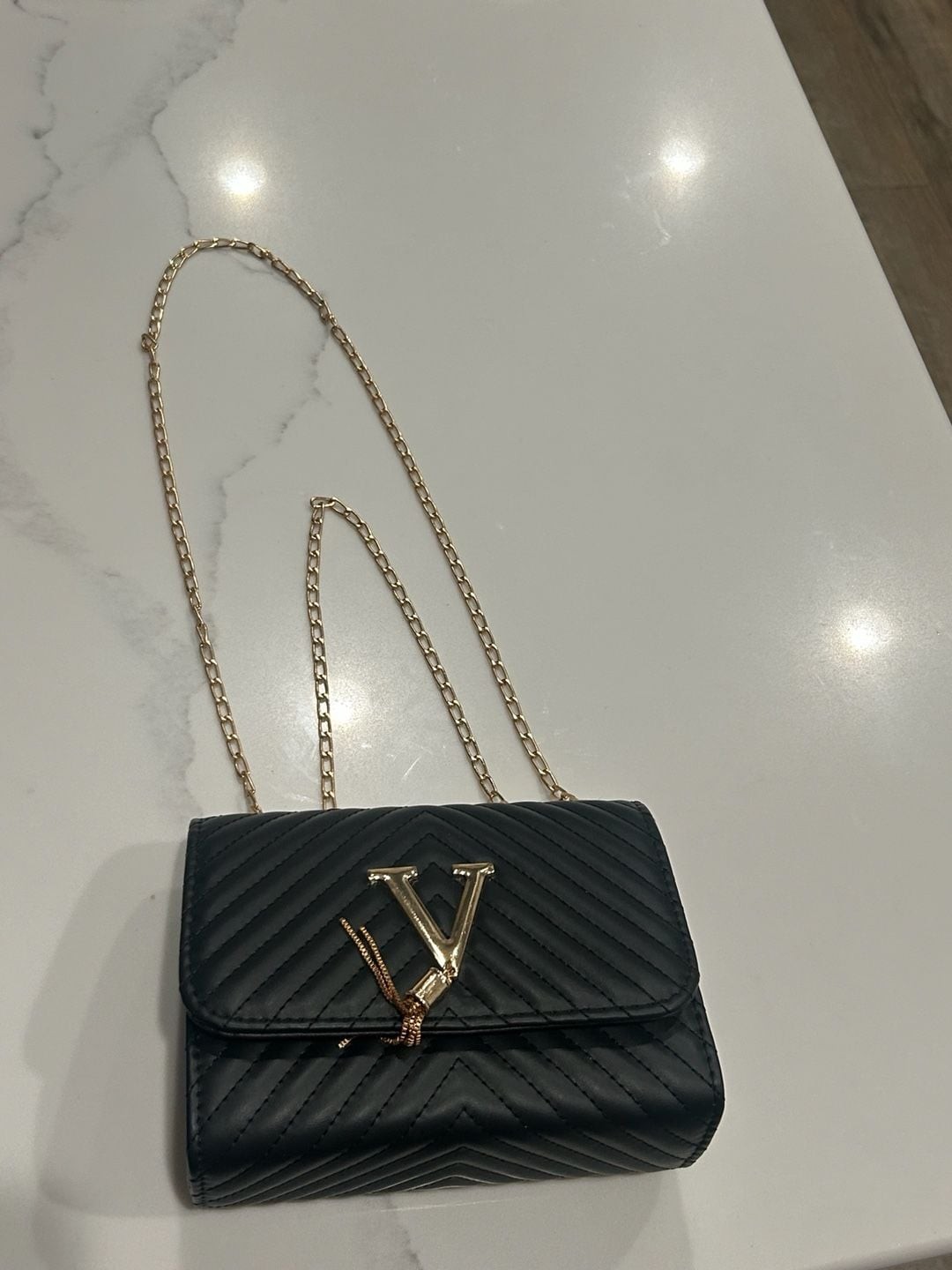 V-Logo Quilted Black Crossbody Bag with Gold Chain and Tassel
