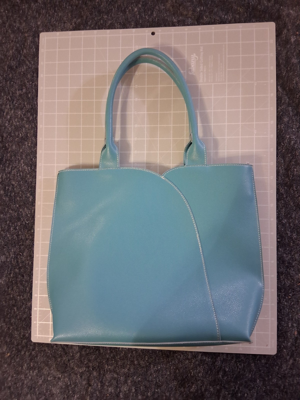 Mellow World tote grained vegan leather tulip curved front panel vibrant teal