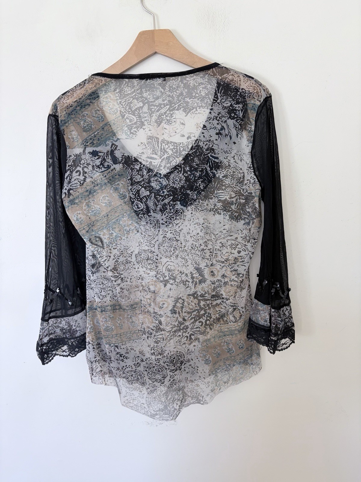 Vintage long sleeve top features a grey and black paisley print with intricate b