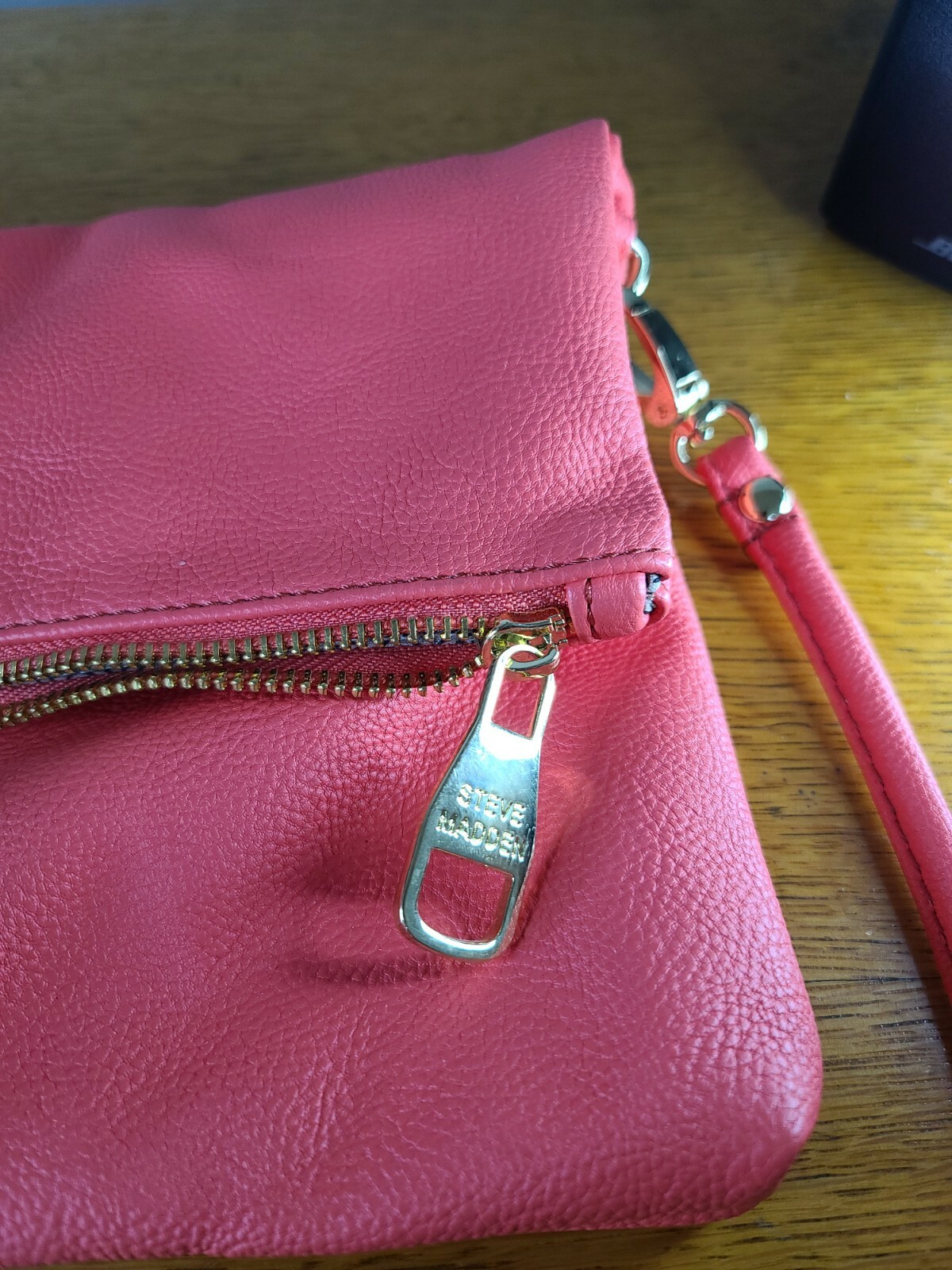 Elevate your style with this stunning Steve Madden clutch in a beautiful coral