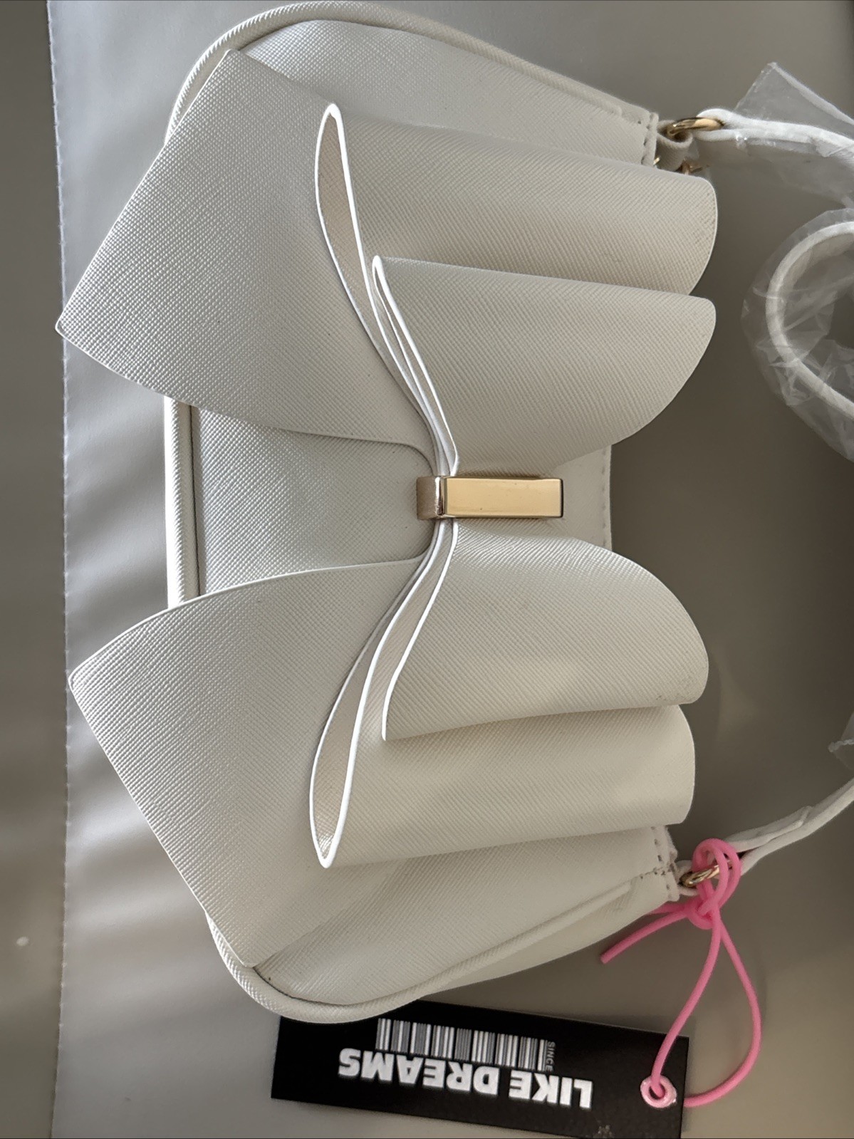 Like Dreams Bowtie Crossbody White Faux Leather Flap Chain Strap Gold Logo