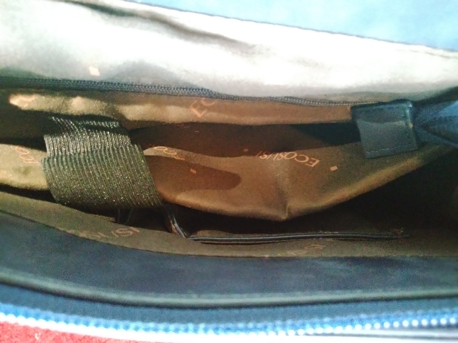 ECOSUSI briefcase features vegan leather construction and a protective handle…