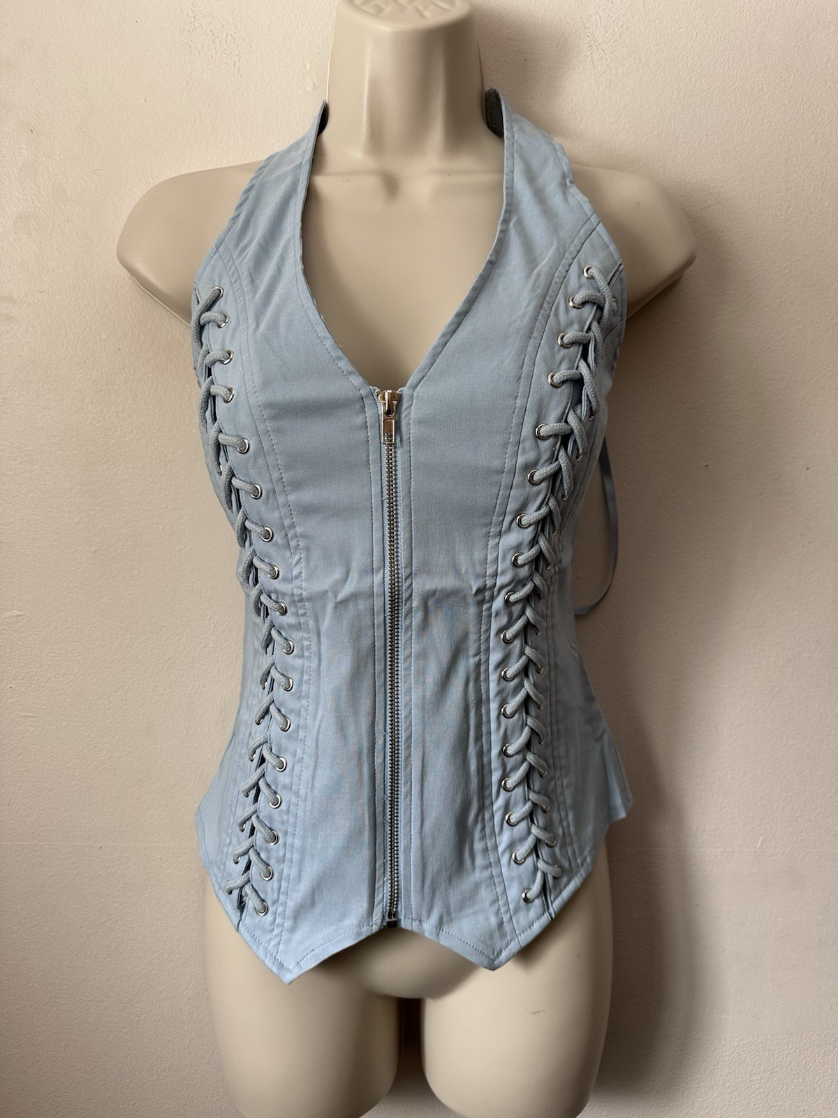 Light blue corset top with zipper and lace up details