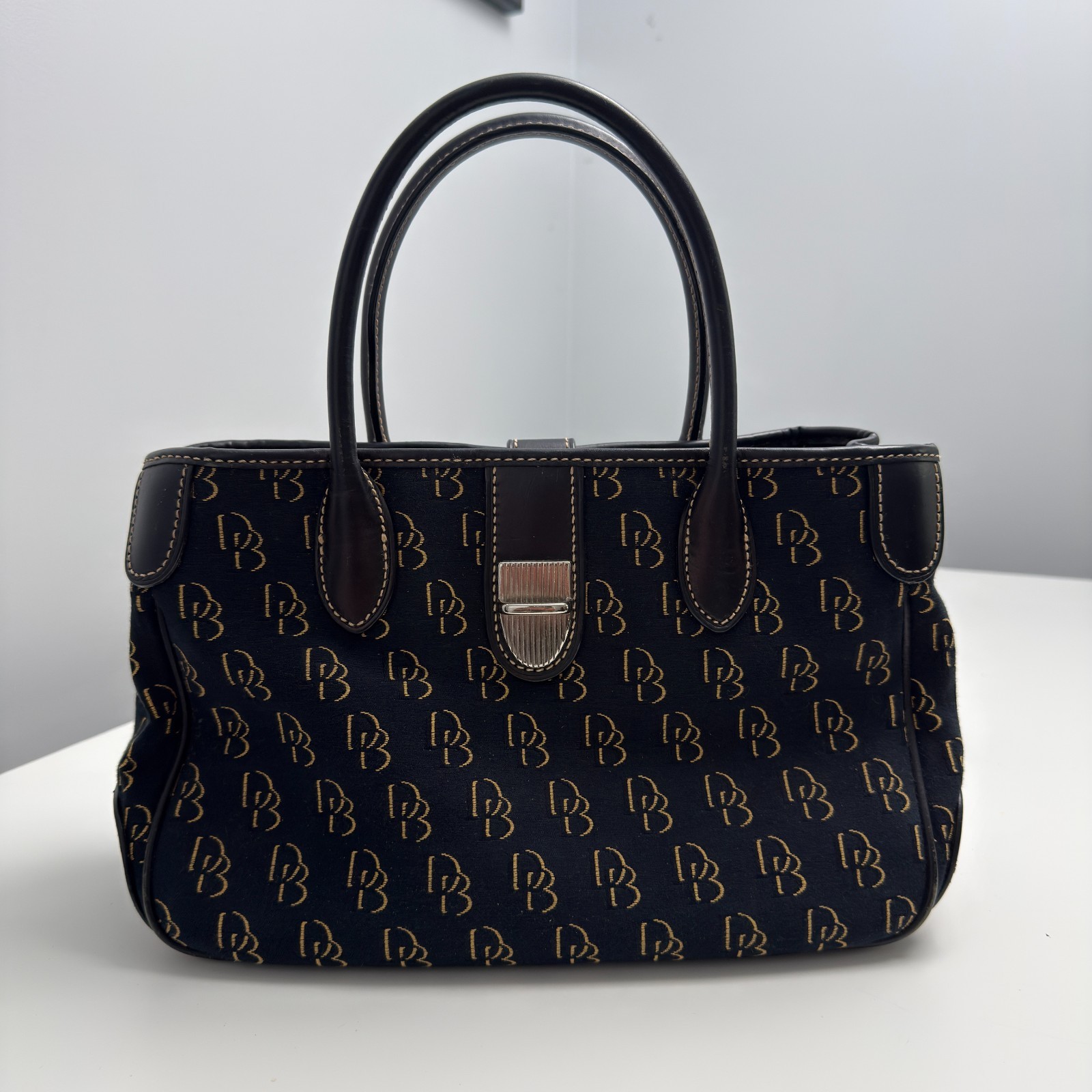 Dooney & Bourke DB Monogram Satchel Purse Black Gold Leather Trim Push Lock