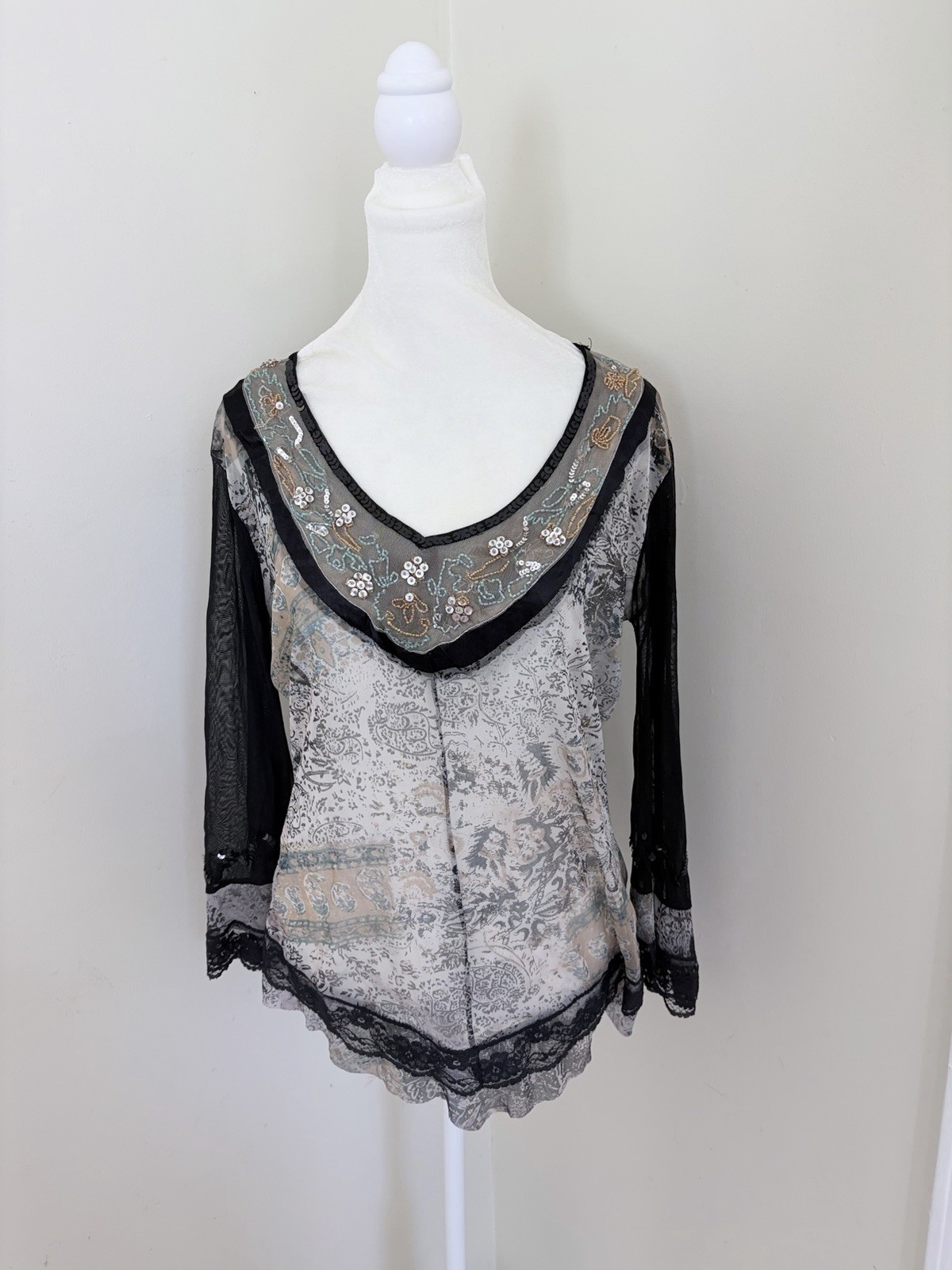 Vintage long sleeve top features a grey and black paisley print with intricate b