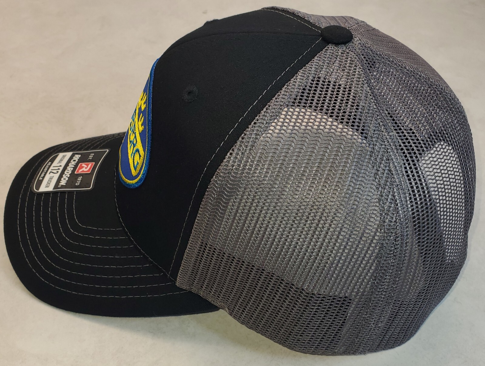 Mossberg Firearms Patch on Richardson 112 Trucker Hat Snapback Black/Charcoal